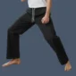 Front view of man stretching while wearing black karate pants.