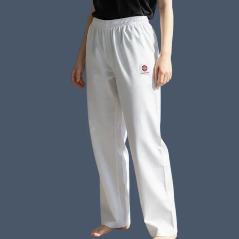 Image shows model wearing white poly cotton 8oz weight canvas karate pants.
