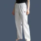 Image shows model wearing white poly cotton 8oz weight canvas karate pants.