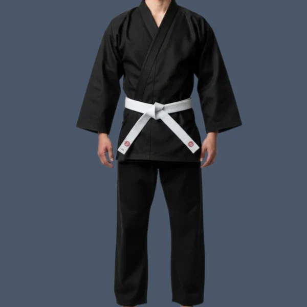 Image shows front view of man wearing black karate uniform with a white belt.