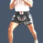 Man wearing Muay Thai shorts featuring 'No Fear' design.