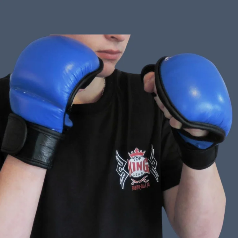View of MMA practitioner wearing blue leather training gloves