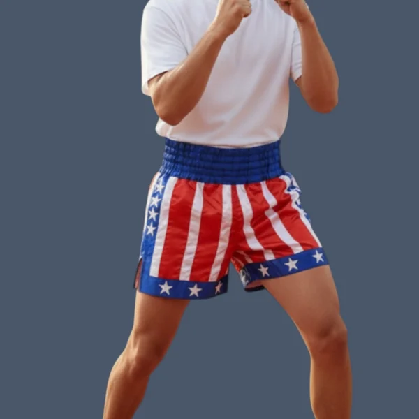 LWKBS_model Man wearing kickboxing training shorts, red and white stripes with blue trim.