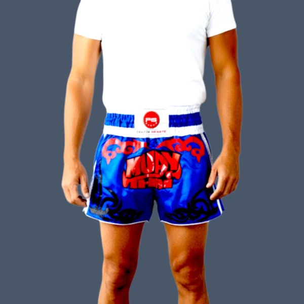 Blue Muay Thai shorts with red and blue design vinyl patch to front.