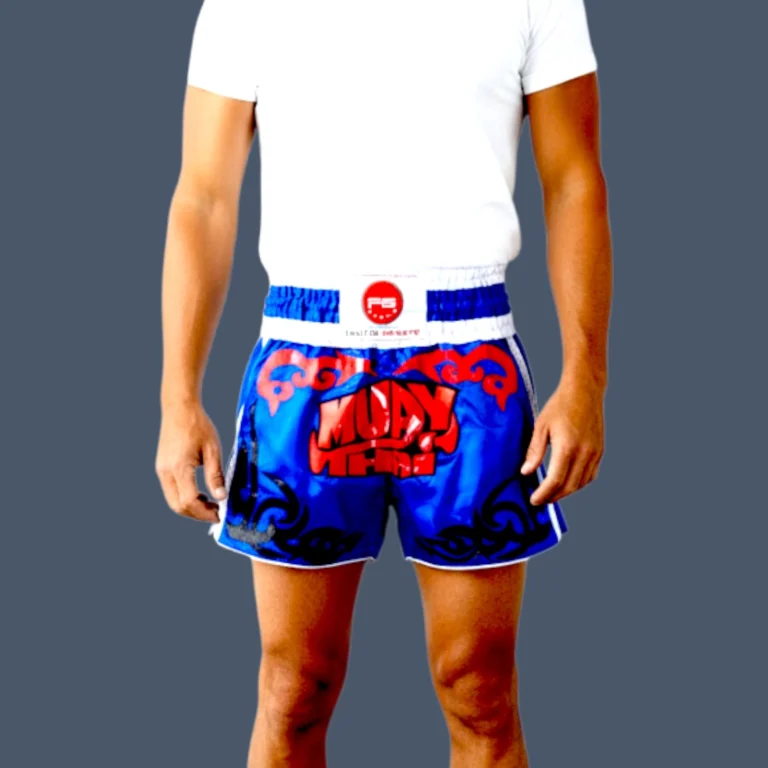 Blue Muay Thai shorts with red and blue design vinyl patch to front.