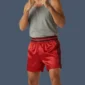 Front view of man wearing red kickboxing shorts