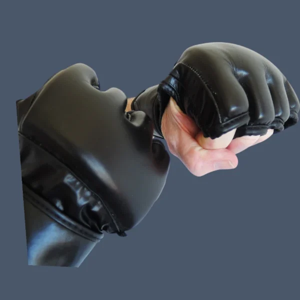 PS 506 leather gloves worn punch fist Image shows MMA gloves over wearers knuckles and back of hand.