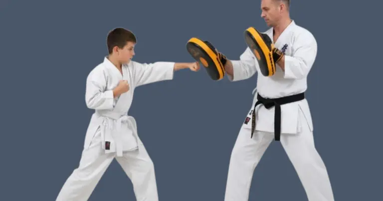 image shows karate instructor holding focus mitts for student to practise