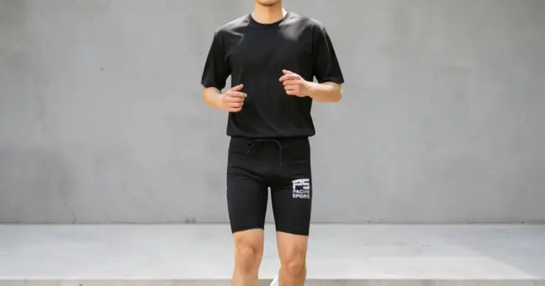 Image of male athlete wearing black compression T shirt and blackcompression shorts