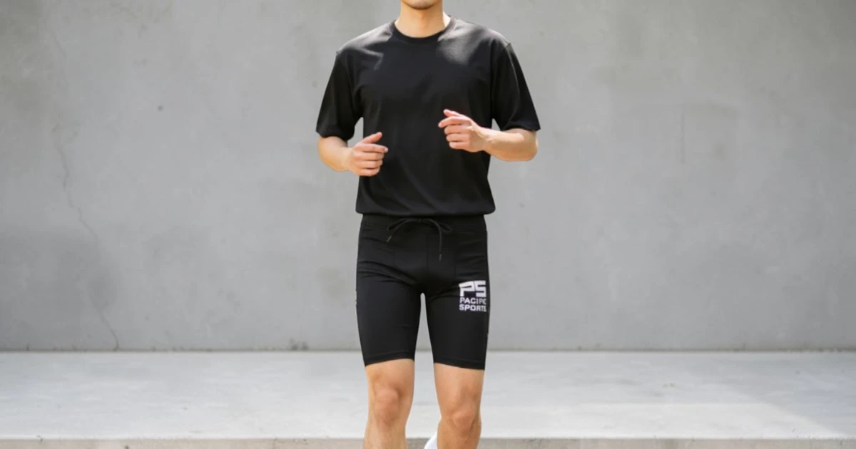 Image of male athlete wearing black compression T shirt and blackcompression shorts