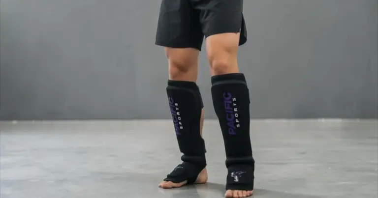 Front view of martial arts student wearing shin pads