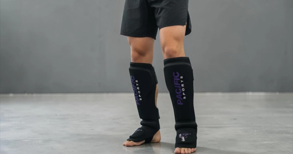 Front view of martial arts student wearing shin pads